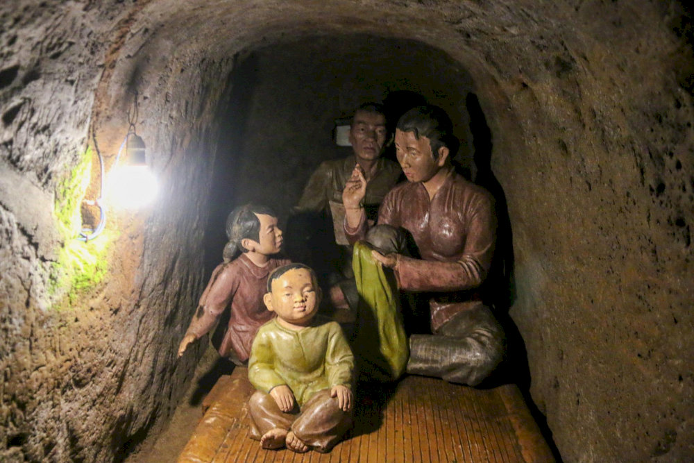 Exhibits include hand tools, personal belongings, and models of the tunnel system